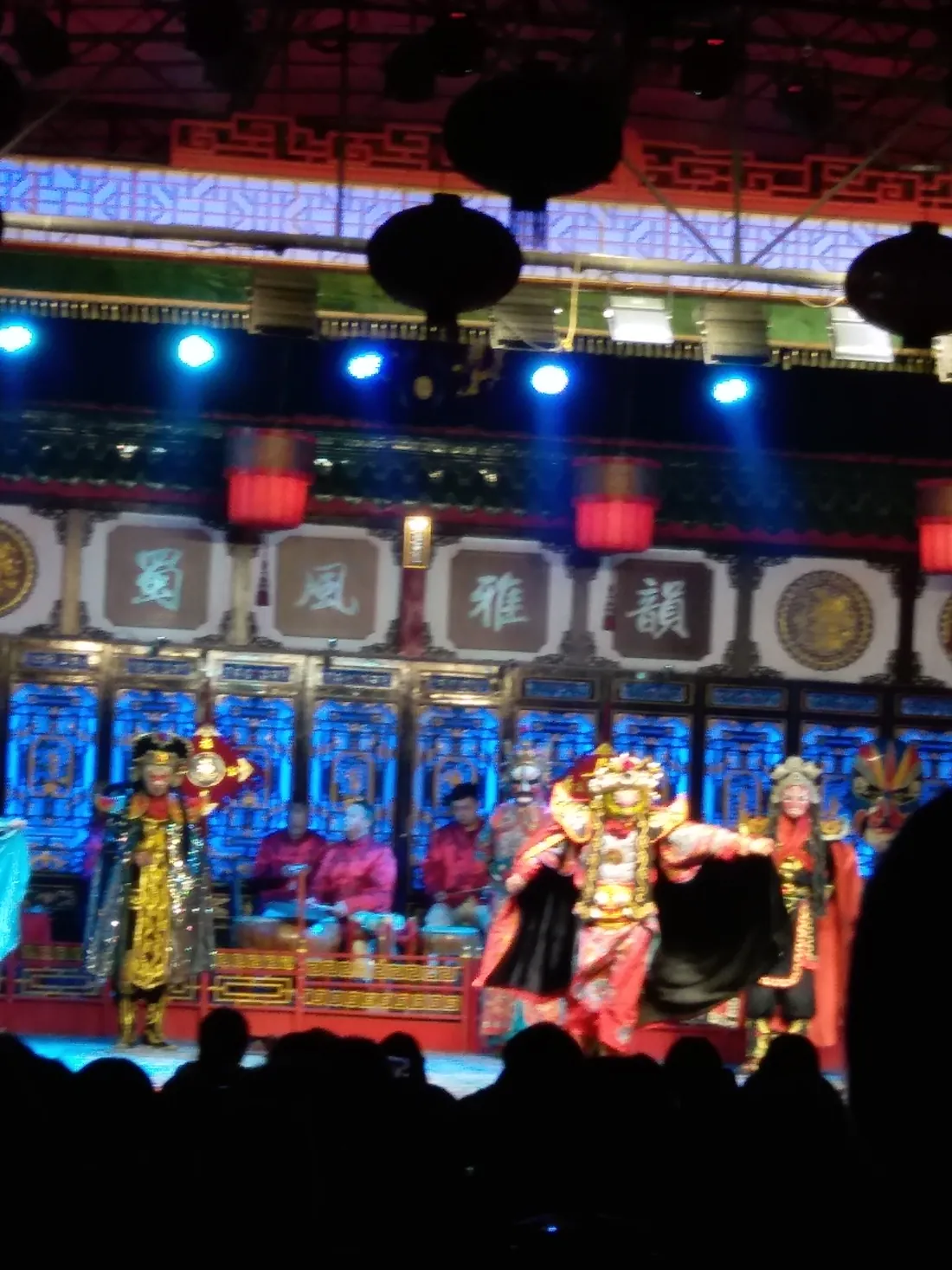 A Sichuan opera bian lian face-changing performer in a brightly coloured mask